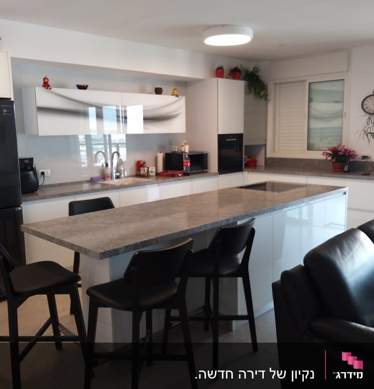 מטבח נקי עם כיור וברז, משטחי עבודה מסודרים